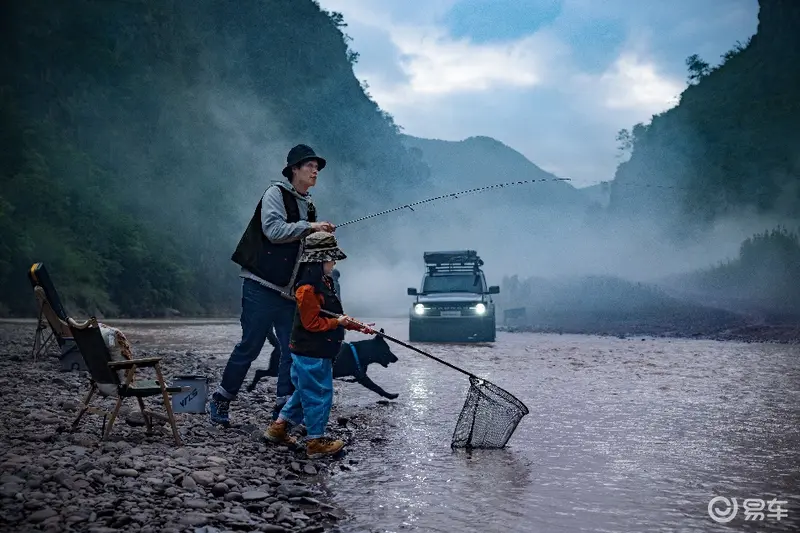 A person and child fishing in a river

Description automatically generated